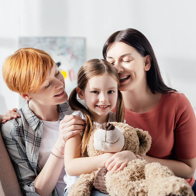 A family hugging their daughter